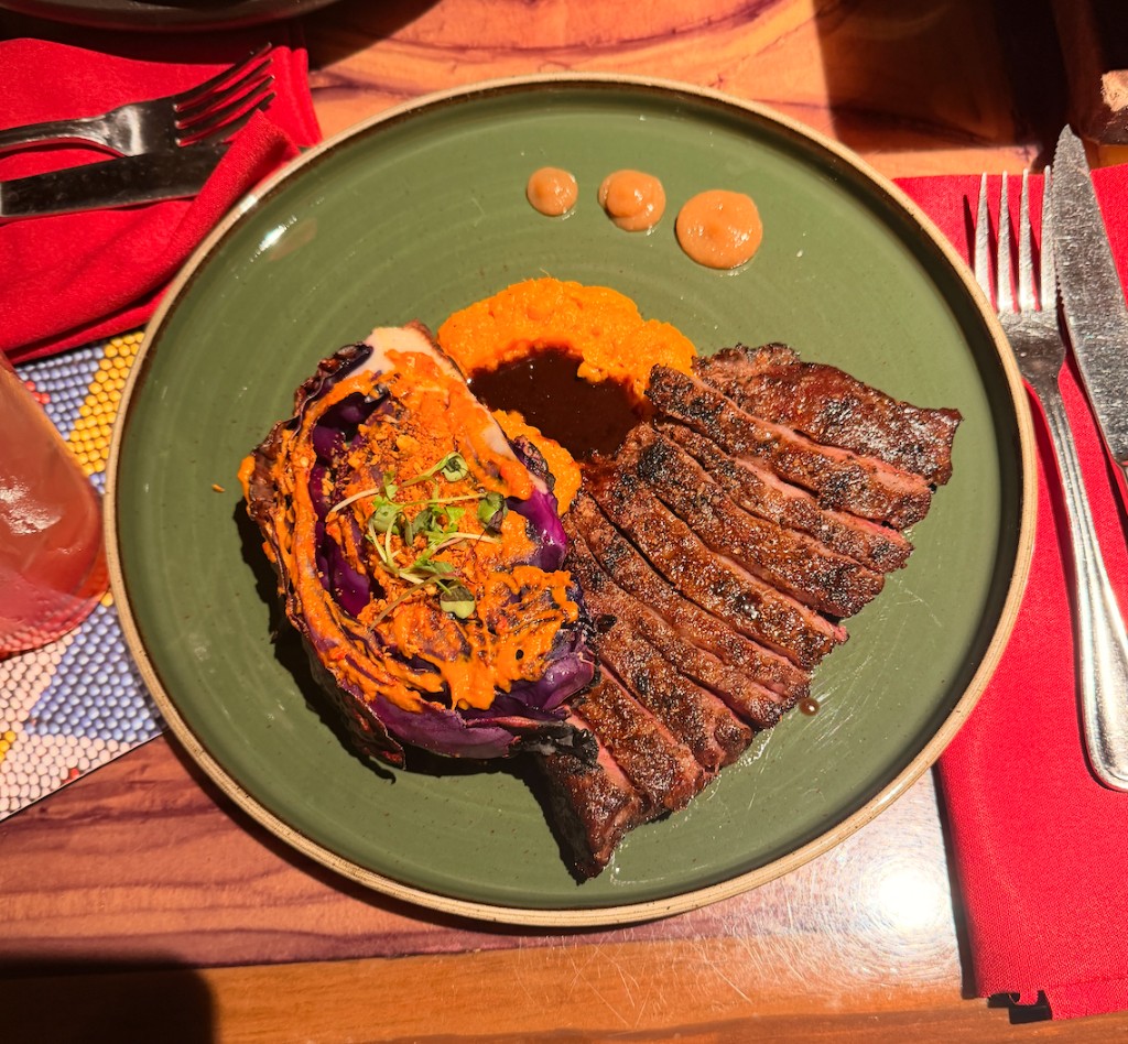 Plated steak dish on green plate