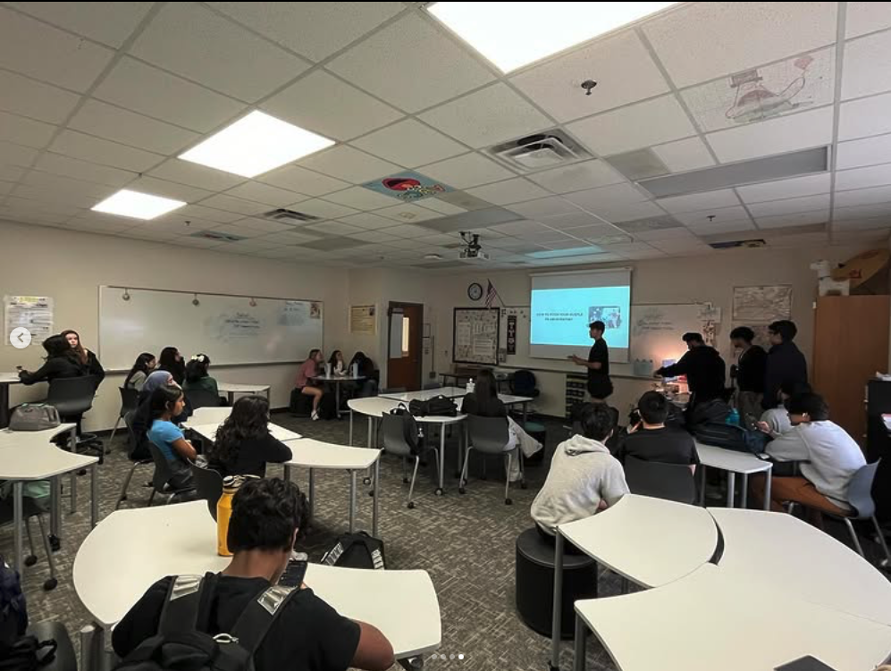 Wide classroom view during a Side Hustle Club presentation